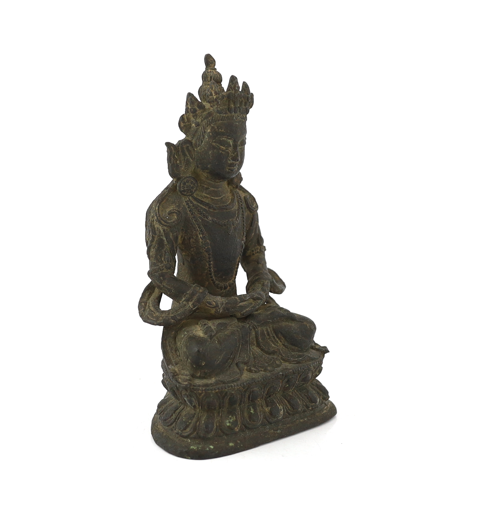 A Chinese bronze seated figure of Amitayus, probably 18th century, surface pitted
